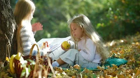 Children Reading Book In The Autumn Park Stock Footage