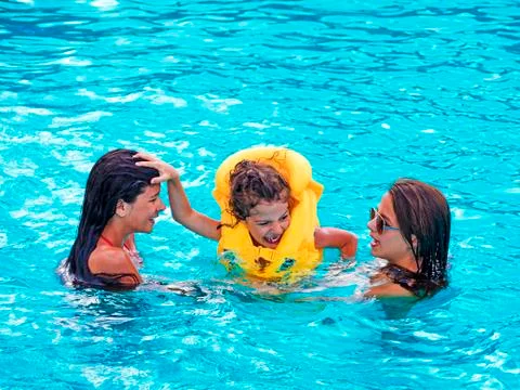 Children rest in the pool in summer Stock Photos