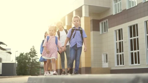 Children return to school with backpacks. Family of children goes to school Vídeos de archivo 168861053