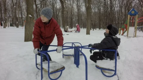 Children ride on the carousel. Deep snow. Video stock 87740331