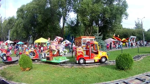 Children ride on a carousel Stock Footage 114376401