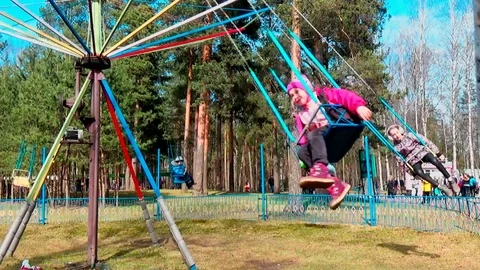 Children ride on the carousel in the park Stock Footage 75204095