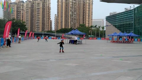 Children roller skating on the square quickly Stock Footage 153142288