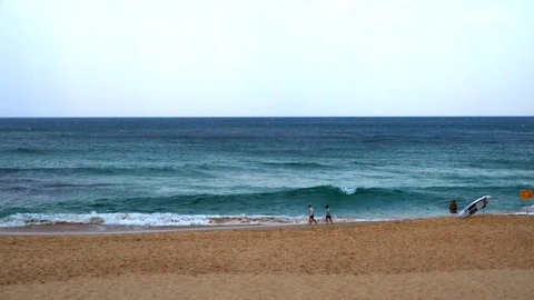 Children run along the sandy beach by the sea Stock Footage 121652003