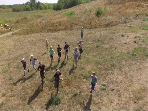 Children run at camera quadrocopters Stock Footage 71249538