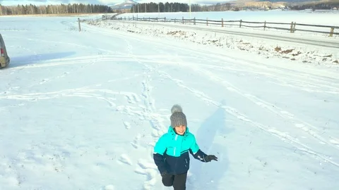 Children run in the snow Stock Footage 120288730