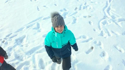 Children run in the snow Stock Footage 120288845