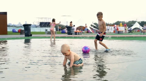 Children Running Around the Puddle Video stock 64764481