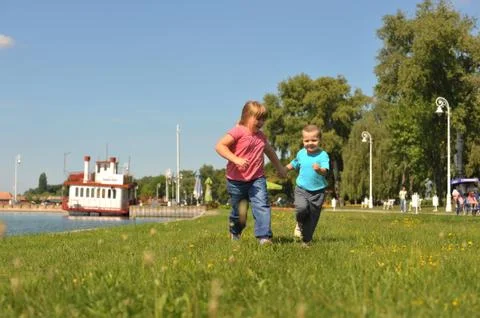 Children running on the grass Stock Photos