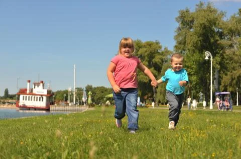 Children running on the grass Stock Photos