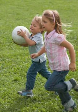 Children running with soccer ball Stock Photos