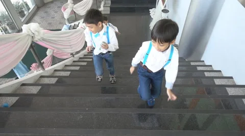 Children running up on step playing together Stockbeeldmateriaal 65824465