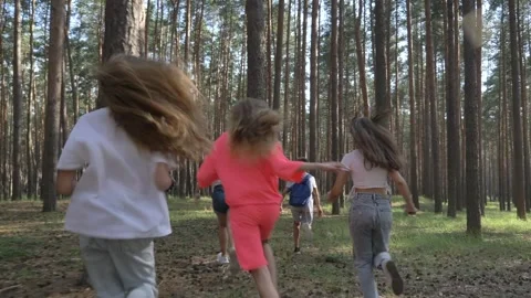 Children running through the forest. Silhouette of a group of children running d Stock Footage 295189515