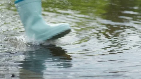 Children Running through Puddle Stock Footage