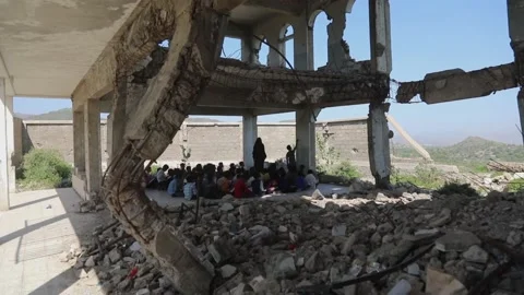 Children in a school destroyed by war Stock Footage 160573983
