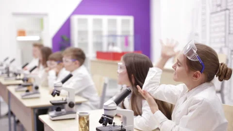 Children at school looking into microscope Stock Footage 86930977
