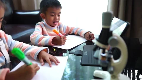 Children with school work from home. Working from home during the Corona Virus p Stock Footage 221179970