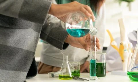 Children scientist doing science experiment test with chemistry in a labora.. Stock Photos