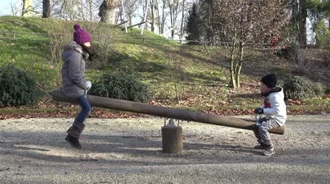 Children on the seesaw - slow motion Stock Footage