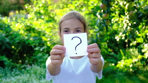 Children shows a question mark on paper. Selective focus. Stock Footage 159665940