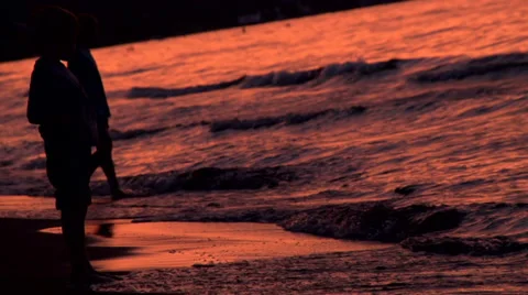 Children Silhouetted by the Setting Sun at the Beach Stock-Footage 35537327