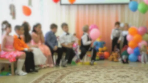 Children sit on chairs and look towards the hall Stock Footage