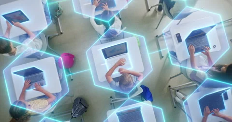 Children Sit at Desks Using Laptops, Surrounded by Luminous Digital Lines Vídeo Stock 319062931