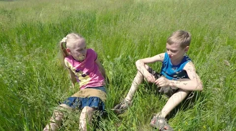 Children sit on the grass. Video stock 51401636
