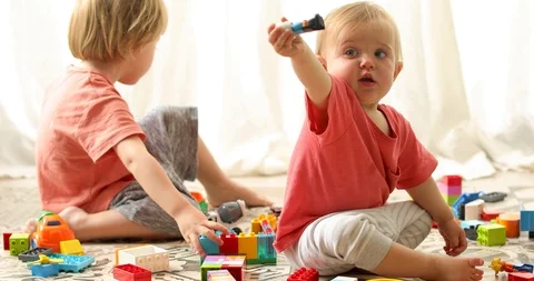 Children sitting and playing with erector set Stock Footage 112014516