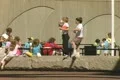 Children sitting and playing near concrete wall Footage
