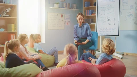 Children Sitting on Bean bags while Teac... | Stock Video | Pond5