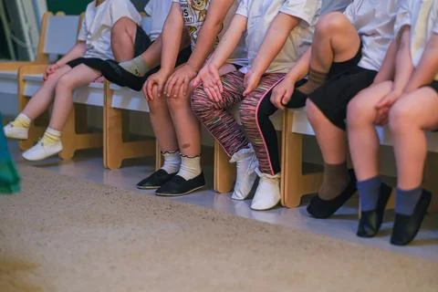 Children sitting on bench in classroom. Group of kids waiting for lesson or Stock Photos