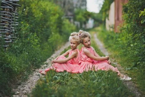 Children sitting in the garden on a rustic path 6622. Stock Photos
