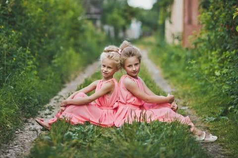 Children sitting in the garden on a rustic path 6623. Stock Photos
