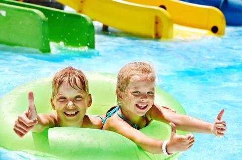 Children sitting on inflatable ring. Stock Photos