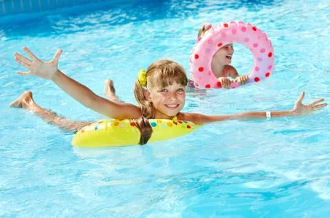 Children sitting on inflatable ring. 스톡 사진