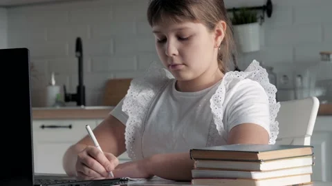 Children Is Sitting At Table And Doing School Homework At Home Stock Footage 230890448