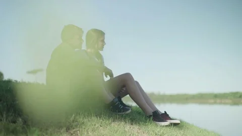 Children sitting together on hillside looking at view Stock Footage 75179728