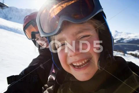 Children In Ski Helmets And Goggles