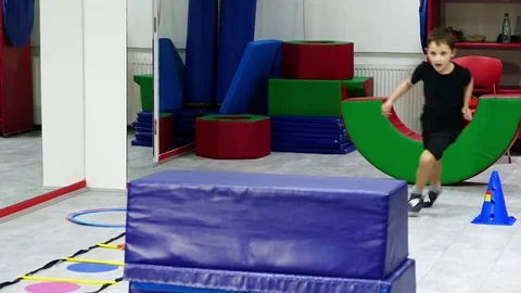 Children skipping obstacles on the training ground. Stock Footage 83624257