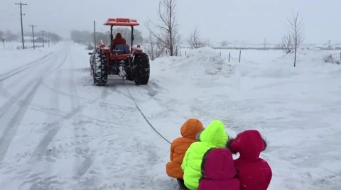 Children sledding behind tractor HD  Stock-Footage 68689597