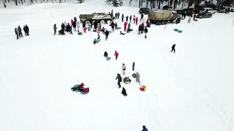 Children sledding down the mountain, shooting from a drone Stock Footage 222716063