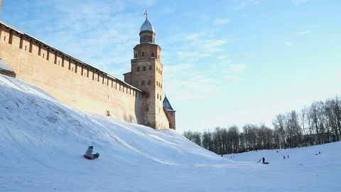 Children sledding downhill in the winter Stock Footage 82669446