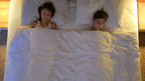 Children sleep in the bed. View from above. Stock Footage 77582445