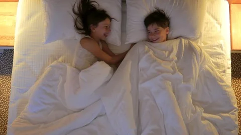  Children sleep in the bed. View from above. Stock Footage 77582809
