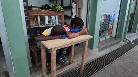 Children sleeping on a table in front of a shop, Inhambane Province, Inhambane, Stockbeeldmateriaal 336735039