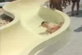 Children sliding down waterslide Footage