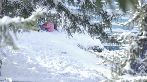 Children sliding on snow Stock Footage 166695873