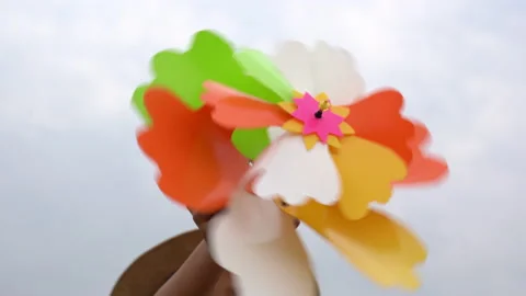 Children smile and playing windmill on sunset nature background Video stock 179624170