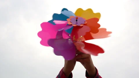 Children smile and playing windmill on sunset nature background Stockbeeldmateriaal 179636493